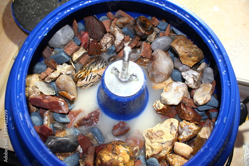 Obraz na plátně Vibratory tumbling bowl filled with stones for processing