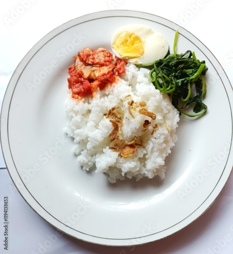 rice with chicken,chilihot chilies, salted fish, boiled eggs, onions, lime, plate photo