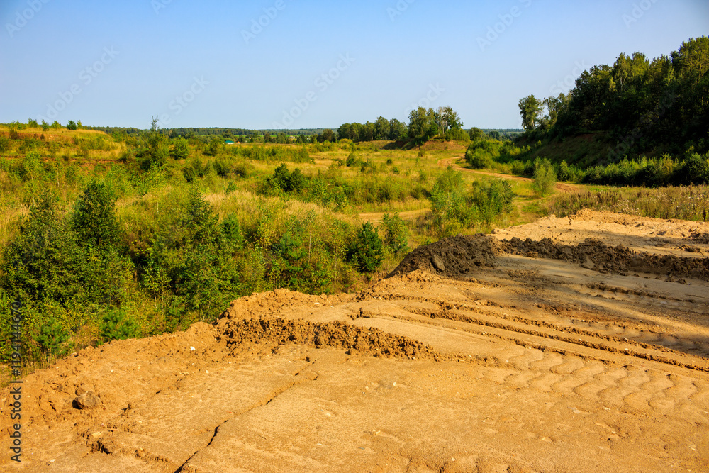 Naklejka premium Overburden dump on the overgrown part of a worked-out quarry