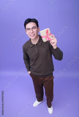 Photo of young Asian man on purple backgroundPhoto of young Asian man on purple background photo