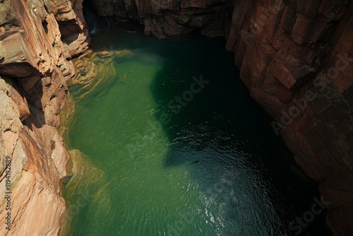 Tranquil waters flow around rugged rocks in Gooseberry Falls State Park, showcasing lush greenery and untouched natural beauty in bright daylight photo