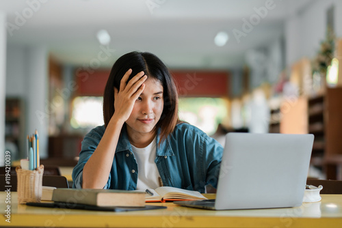 Young Woman Studying at Home with Laptop and Books in Cozy Living Room Interior for Online Learning and Education Concept. photo