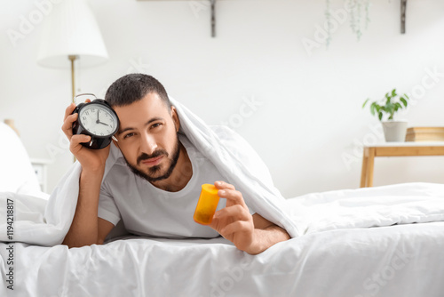 Stressed young man with ala...