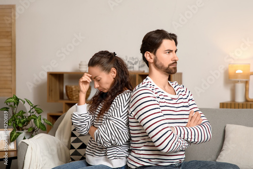 Unhappy couple sitting on s...