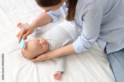 Mother brushing her little ...