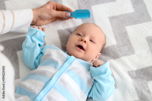 Mother combing little baby'...