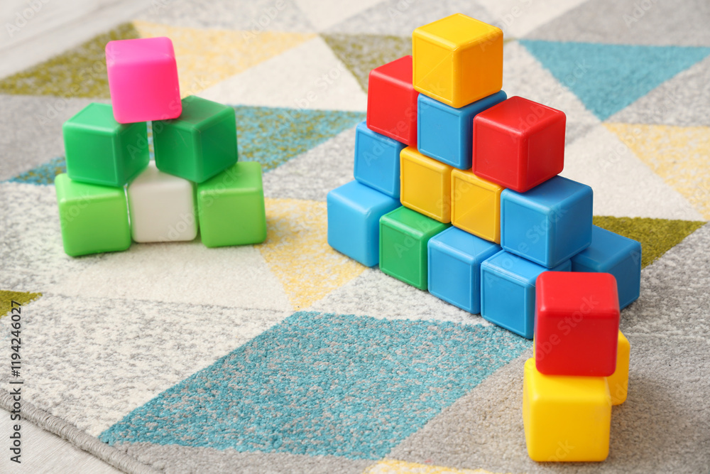 Obraz premium Colorful cubes on floor in children's bedroom, closeup