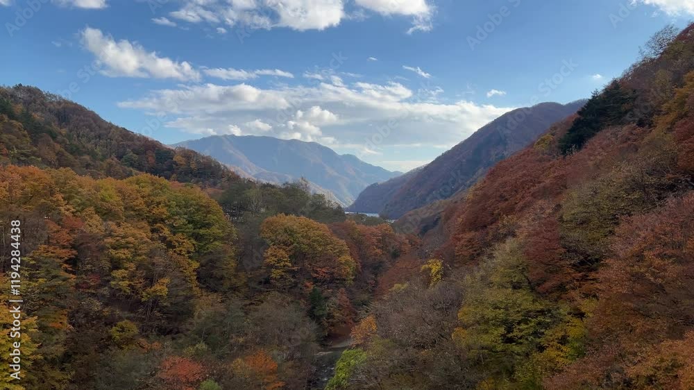 Looking out on autumn color landscape with mountain and blue sky in distance Looking out on autumn color landscape with mountain and blue sky in distance
