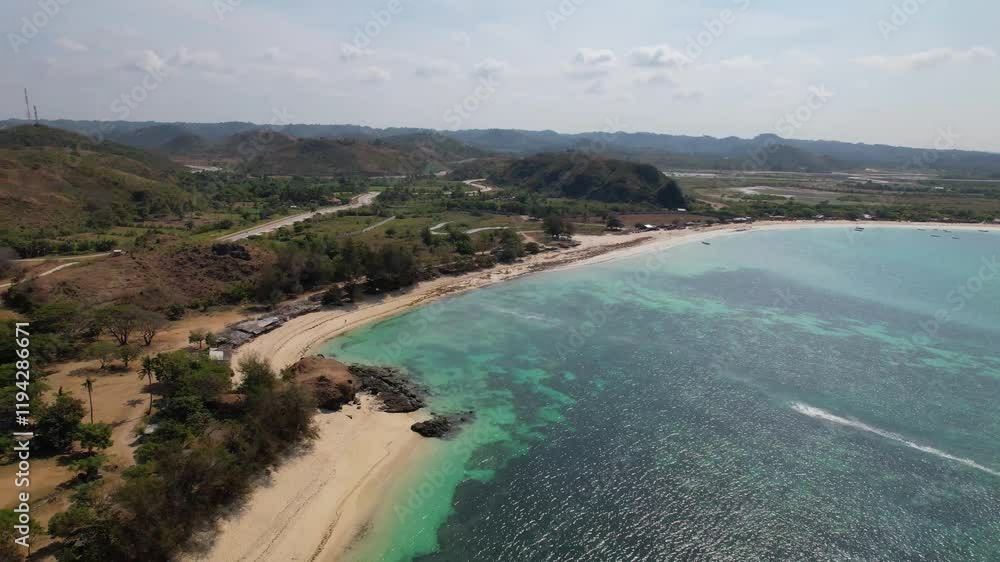 4k drone video of Tanjung Aan Beach, a white sand beach with turquoise crystal clear water surrounded by mountains and natural landscapes in Kuta Lombok, Indonesia 4k drone video of Tanjung Aan Beach, a white sand beach with turquoise crystal clear water surrounded by mountains and natural landscapes in Kuta Lombok, Indonesia