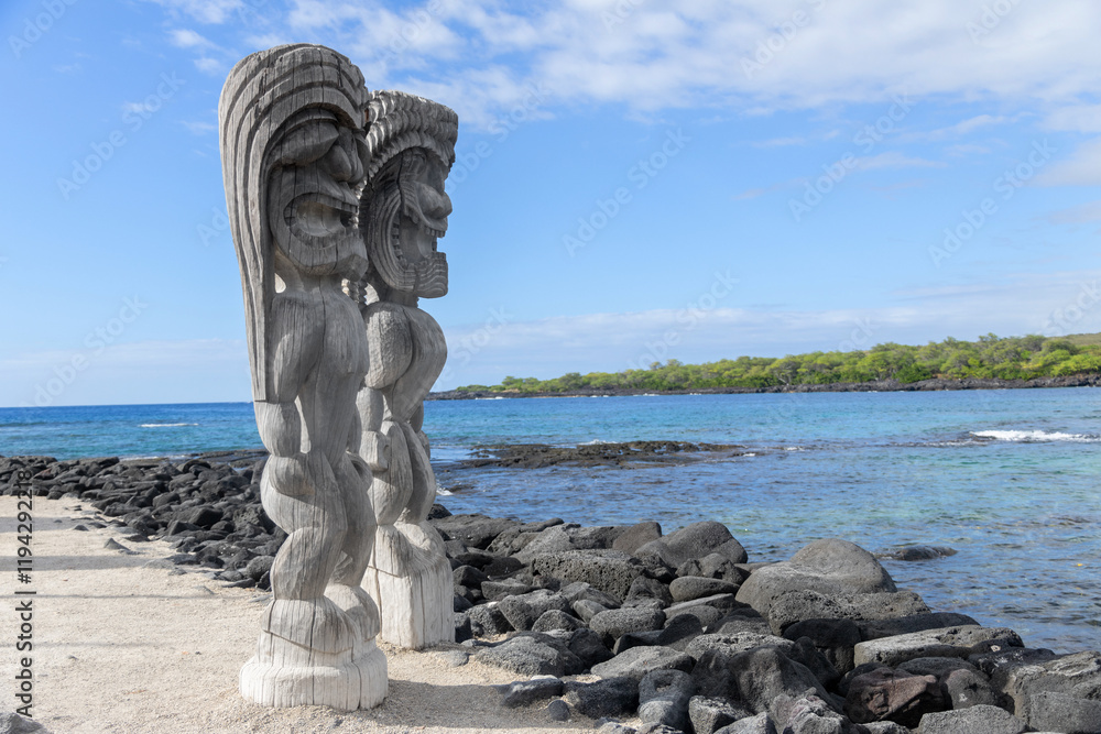 Wooden carved statues of Hawaiian gods, Protectors ki'i, at the shore of Pacific ocean. Puʻuhonua o Hōnaunau national historical park, Hawaii, the USA. Wooden carved statues of Hawaiian gods, Protectors ki'i, at the shore of Pacific ocean. Puʻuhonua o Hōnaunau national historical park, Hawaii, the USA.