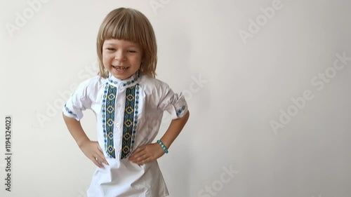 A little boy dressed in Ukrainian traditional clothes, vyshyvanka. Smiling child looking at the camera. Portrait of a little kid smiling child looking at the camera. Children's smile. Close-up face