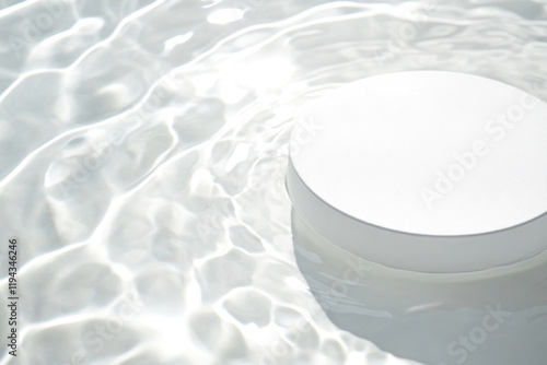 White object floating in pool, surrounded by colorful inflatable toys, green palm trees in the background. Sunny day, serene water reflecting the clear sky.