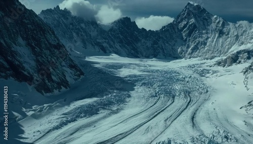A breathtaking view of a glacier surrounded by towering mountains.