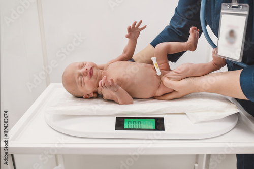 Nurse with newborn baby in postpartum ward. Medical staff caring, weighing a newborn baby on scales in prenatal hospital.
 photo