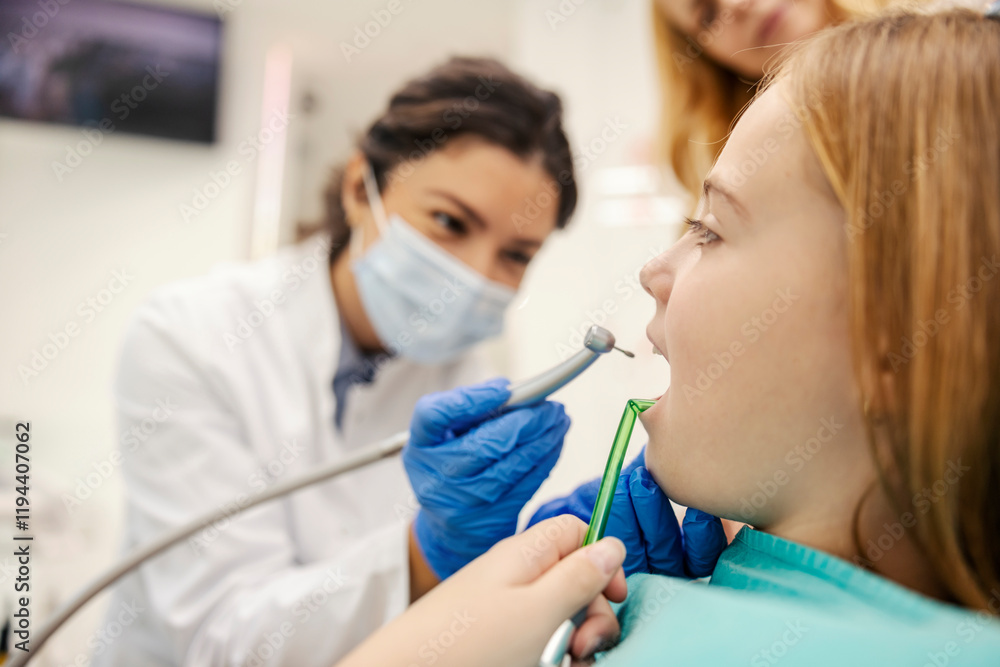 Close up of girl sitting in chair at dentist office and getting tooth drilled. Close up of girl sitting in chair at dentist office and getting tooth drilled.