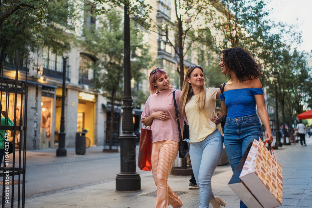 Fototapeta premium Three young women walking and shopping on a city street