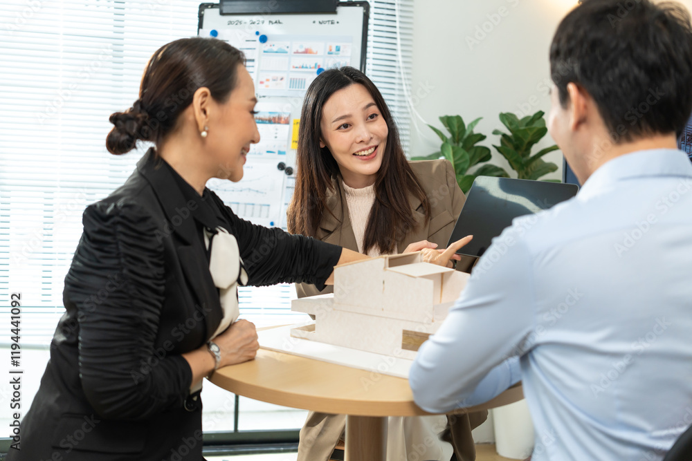 Business team analyzing architectural model during project presentation and strategy meeting in modern workspace Business team analyzing architectural model during project presentation and strategy meeting in modern workspace