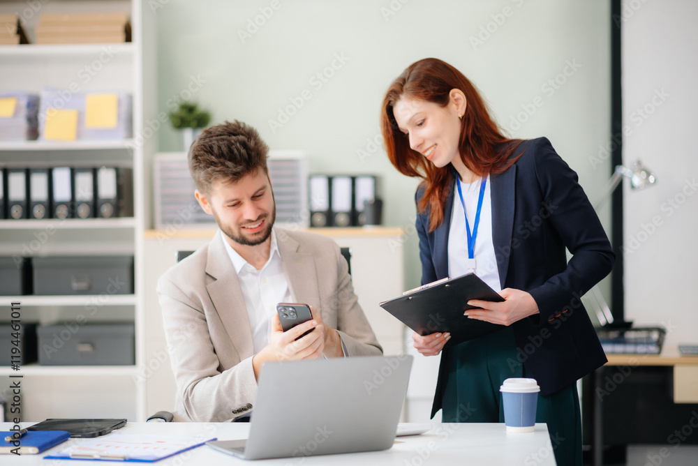 Two business workers talking on the smartphone and using laptop at office. Two business workers talking on the smartphone and using laptop at office.