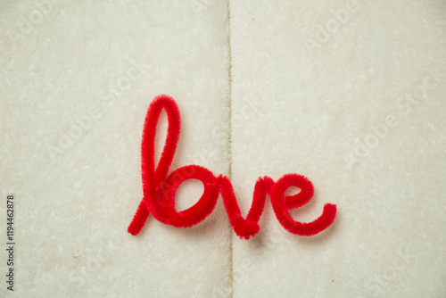 Top View of Red Love Letter Made from Pipe Cleaners, DIY Scarf, with soft background lines in the middle