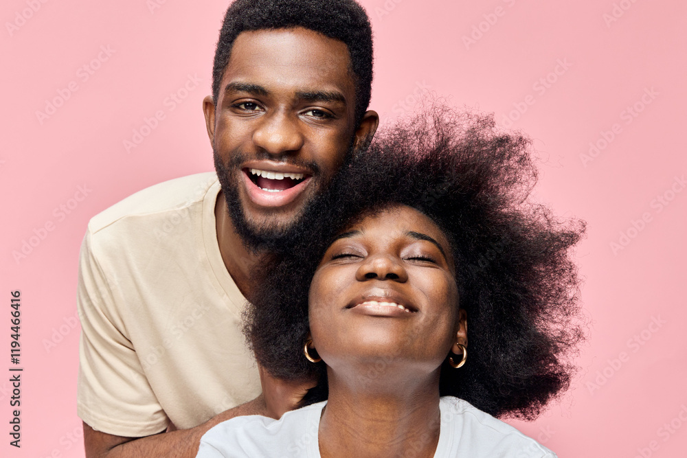 Happy young couple with joyful expressions against a pink background, showcasing love and connection, perfect for themes of happiness and relationships Happy young couple with joyful expressions against a pink background, showcasing love and connection, perfect for themes of happiness and relationships