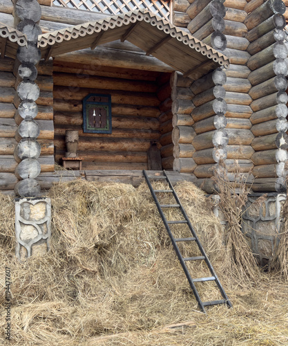 A ladder is leaning against a pile of hay photo