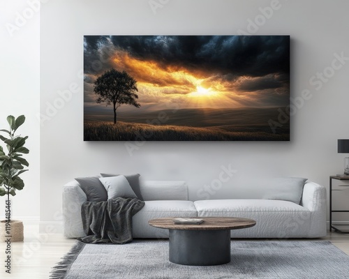 Dramatic sunset landscape print displayed on a living room wall above a light gray couch. photo