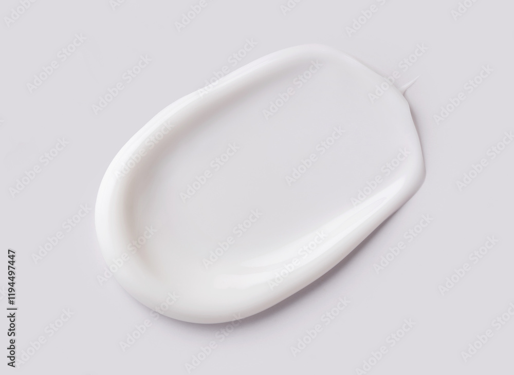 cosmetic smear of creamy texture on a light gray background cosmetic smear of creamy texture on a light gray background