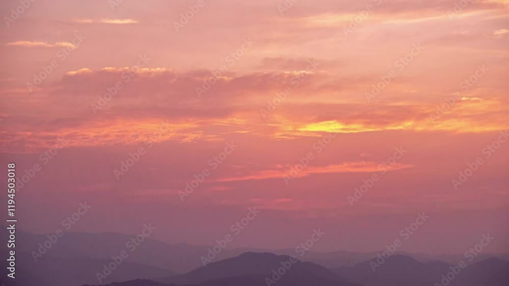 Stunning pink sunset with fiery clouds captured in a mesmerizing time lapse over mountain landscape Stunning pink sunset with fiery clouds captured in a mesmerizing time lapse over mountain landscape