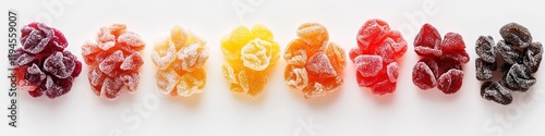 Rainbow array of freeze-dried fruit on white surface. photo