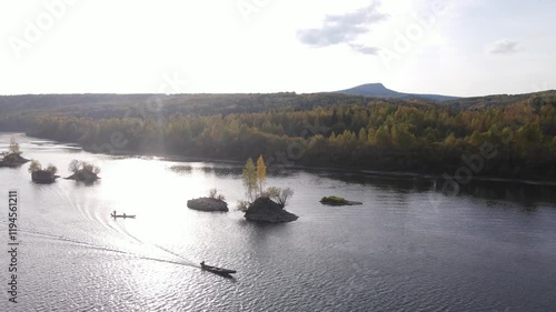 Flight over a sunny autumn forest and river