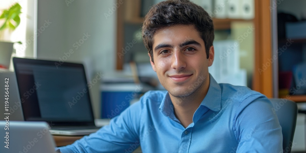 Professional Young Man Smiling at Camera in Office Professional Young Man Smiling at Camera in Office