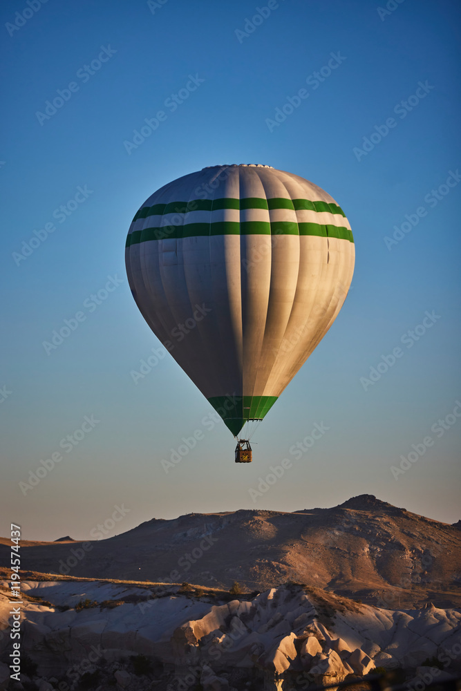 Obraz premium Balloons lifted into the air in Cappadocia. Entertainment and tourist attraction. A spectacular sight