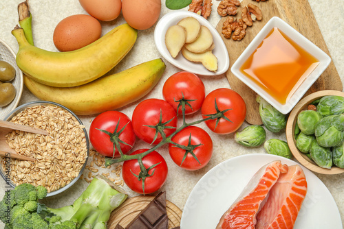 Different fresh products rich in melatonin on light table, flat lay photo