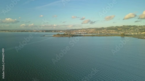 Breathtaking aerial view capturing the serene expanse of Cesar Chavez Park, Berkeley Marina, and the cityscape of Berkeley, California, under a picturesque sky photo