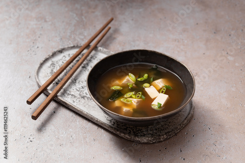 Traditional Japanese Miso soup with Wakame seaweed and tofu cheese with chopsticks for single serving. Vegetarian, vegan and healthy concept. Asian food.