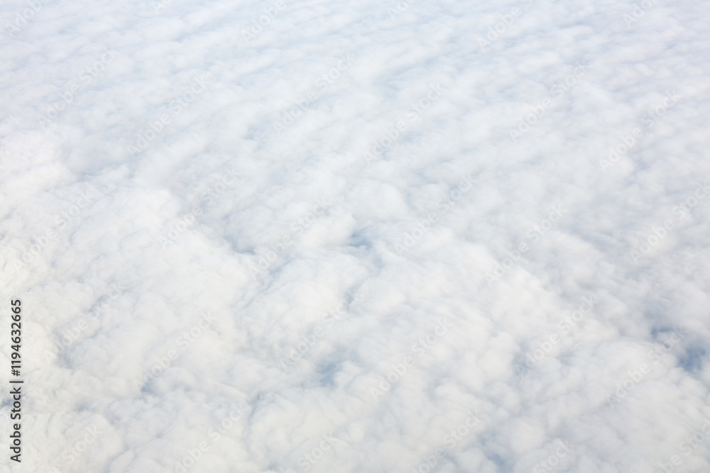 Aerial view over surface of white dense clouds Aerial view over surface of white dense clouds