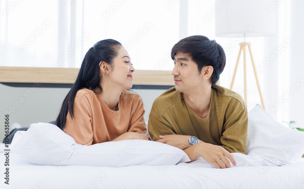 Portrait of young asian lovely sweet attractive cheerful happy couple love smile playing and relax on white bed in bedroom at home good time romantic together Valentine's Day and relationship concept. Portrait of young asian lovely sweet attractive cheerful happy couple love smile playing and relax on white bed in bedroom at home good time romantic together Valentine's Day and relationship concept.