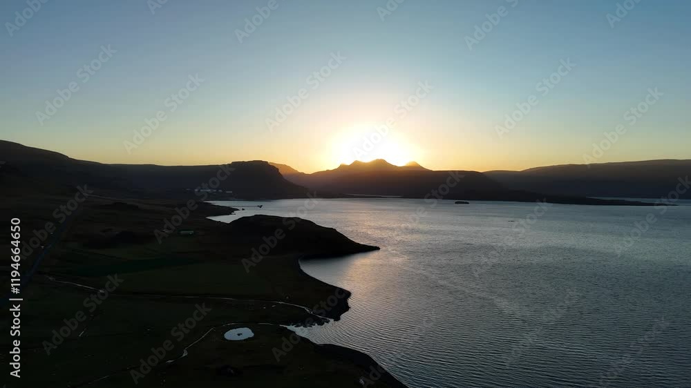 A serene aerial view of an Icelandic fjord at sunset, with glowing golden light over waters, shadowed mountains, and lush green meadows. A tranquil landscape capturing the essence of Nordic beauty A serene aerial view of an Icelandic fjord at sunset, with glowing golden light over waters, shadowed mountains, and lush green meadows. A tranquil landscape capturing the essence of Nordic beauty