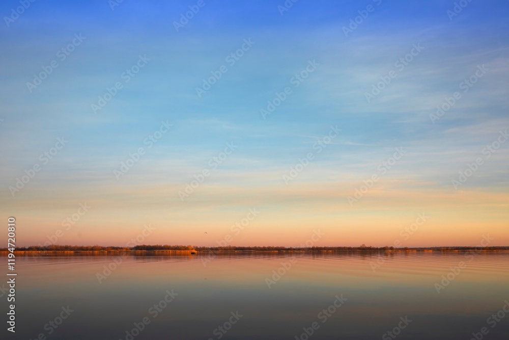 Lake Surface at Sunset with Golden Reflections and Gentle Sky Colors Lake Surface at Sunset with Golden Reflections and Gentle Sky Colors