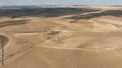 Panoramic View: Bavet Amid Desert Landscapes and Circular Green Irrigation Patches photo