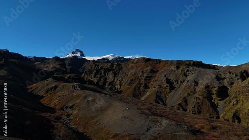 Wallpaper Mural A stunning Icelandic mountainous landscape showcasing the rugged terrain with vibrant autumnal hues on the slopes, leading up to snow-capped peaks under a clear blue sky, evoking a sense of adventure. Torontodigital.ca