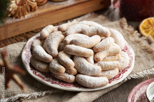 Homemade Christmas cookies called Kipferl or vanilla crescents coated in sugar on a plate photo