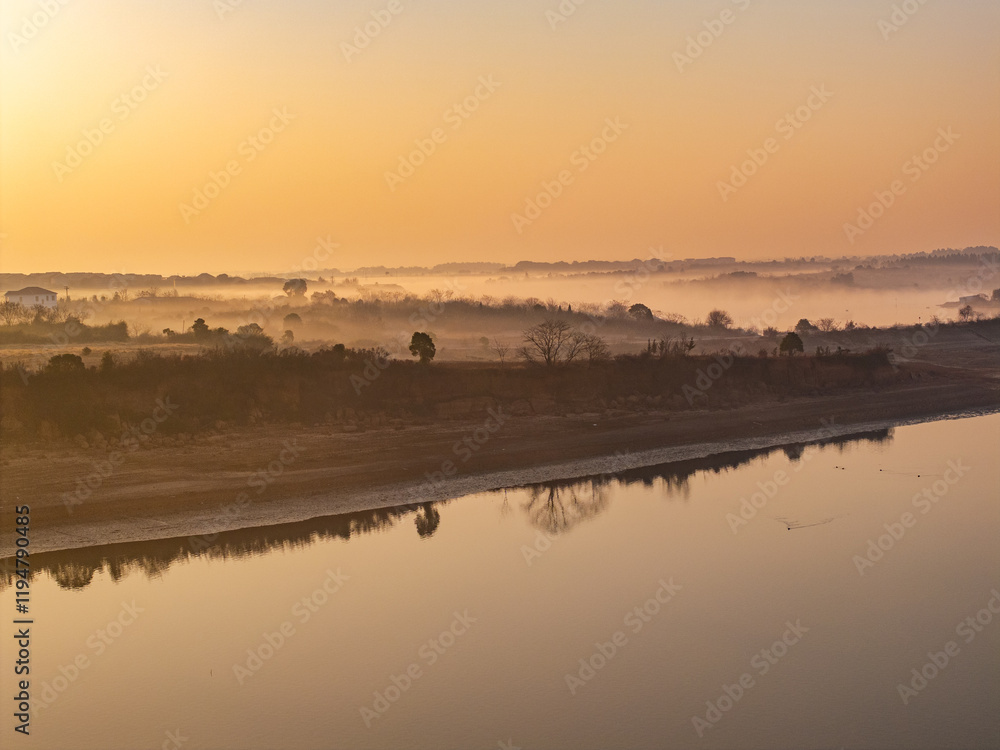 Naklejka premium Sunrise and fog in rural forest