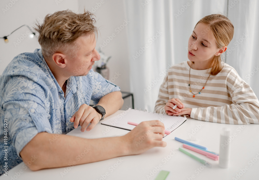 Happy Father And Little Girl Learn Together. Father Helps Little Girl With Homework At Home Happy Father And Little Girl Learn Together. Father Helps Little Girl With Homework At Home