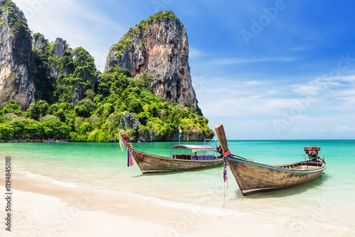 Two thai traditional wooden longtail boats and beautiful sand Railay Beach in Krabi province. Ao Nang, Thailand.
