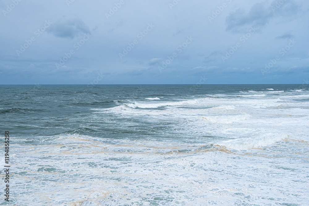 Big waves near the lighthouse at Praia do Norte, Nazare, Portugal Big waves near the lighthouse at Praia do Norte, Nazare, Portugal