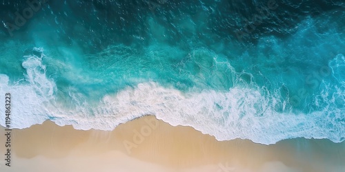 Aerial view of a tranquil beach with turquoise waves meeting golden sand captured from above highlighting natural textures and colors.