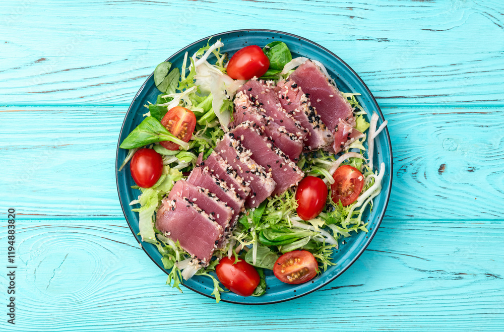 Salad with raw tuna , sesame and cherry tomatoes photography . Top view Salad with raw tuna , sesame and cherry tomatoes photography . Top view