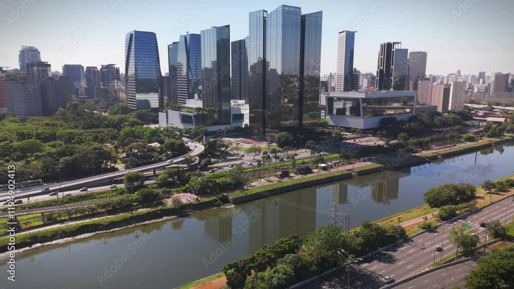aerial view of Sao Paulo city in Brazil with a park, buildings, and Pinheiros river crossing the city. Marginal Pinheiros avenue with traffic during daylight aerial view of Sao Paulo city in Brazil with a park, buildings, and Pinheiros river crossing the city. Marginal Pinheiros avenue with traffic during daylight