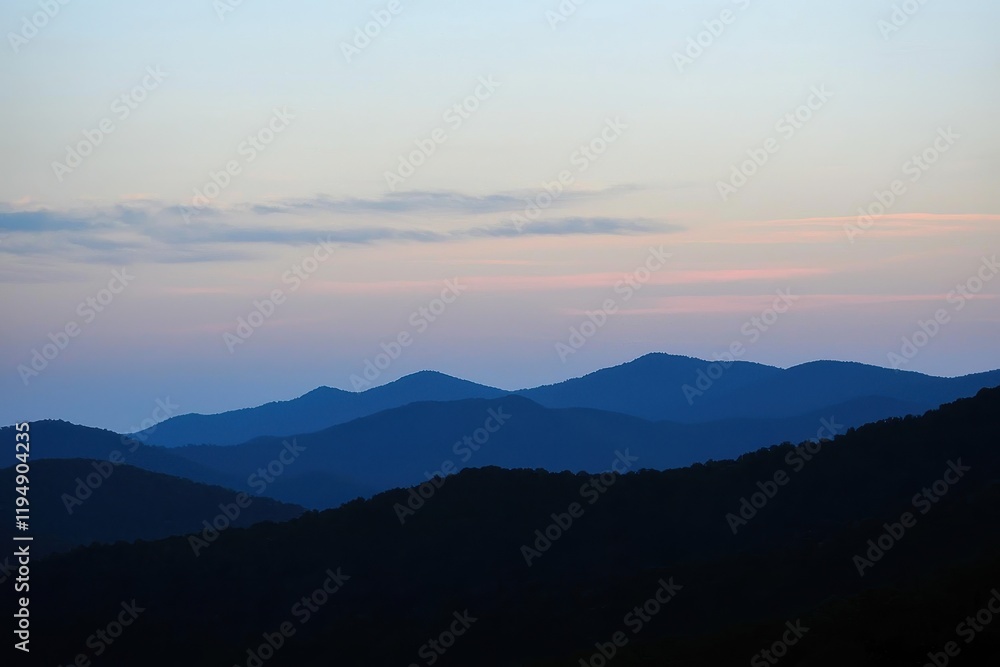 Mountain Range Gradient: Mountains in silhouette with a gradient sky from dark blue at the peak to a light blue at the base Mountain Range Gradient: Mountains in silhouette with a gradient sky from dark blue at the peak to a light blue at the base